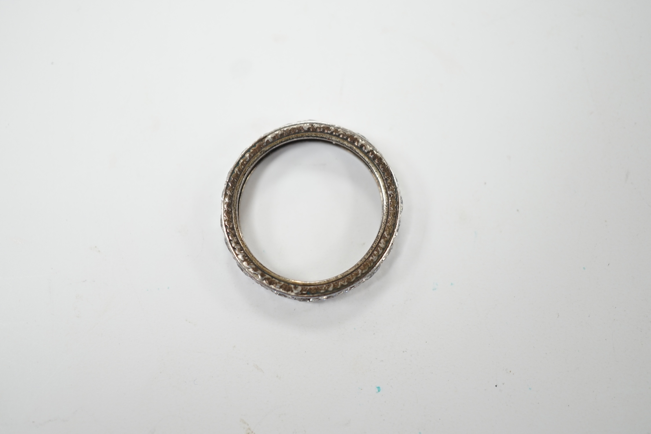 A white metal and diamond set full eternity ring, size L, gross weight 3.1 grams. Fair condition.
